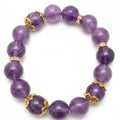 Purple beaded bracelet with gold accents on a white background