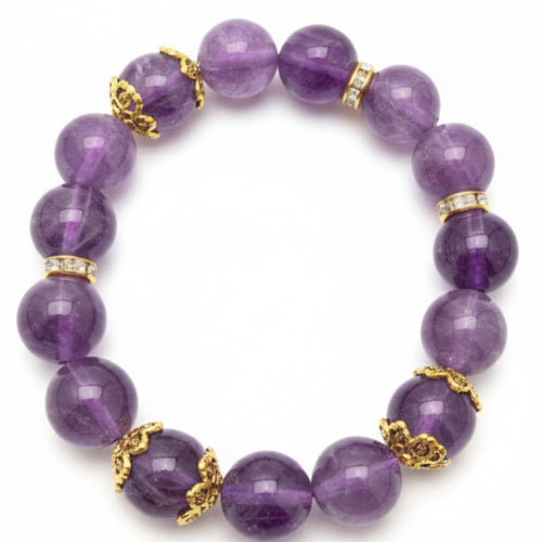 Purple beaded bracelet with gold accents on a white background