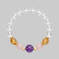 Clear quartz gemstone bead bracelet with amethyst, rose quartz and rutilated citrine centrepiece beads and gold-plated spacers